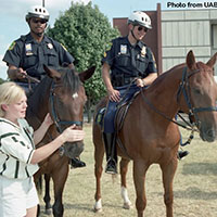 A UAB student and 2 mounted police on the UAB campus. 