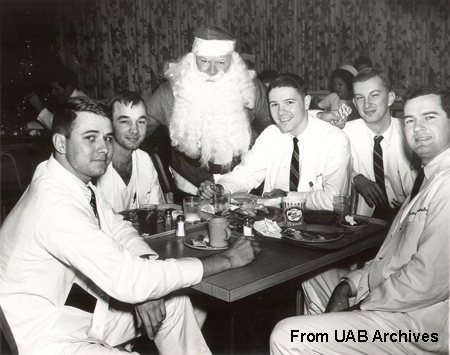 Five male students pose with Santa Claus