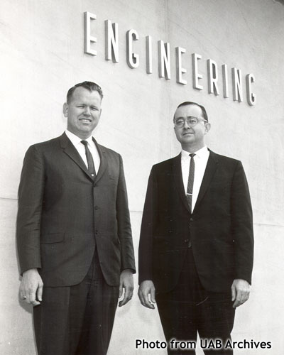 Two men stand outside the engineering building