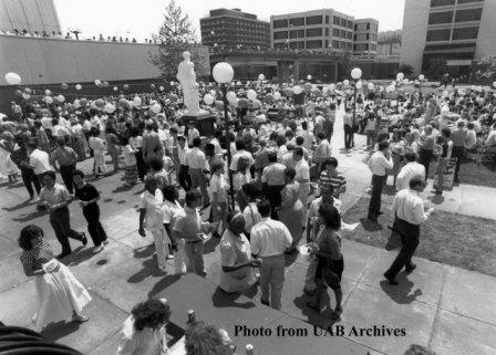 A crowd gathers in the courtyard at Volker Hall