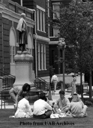 A group  of students sit on the grass