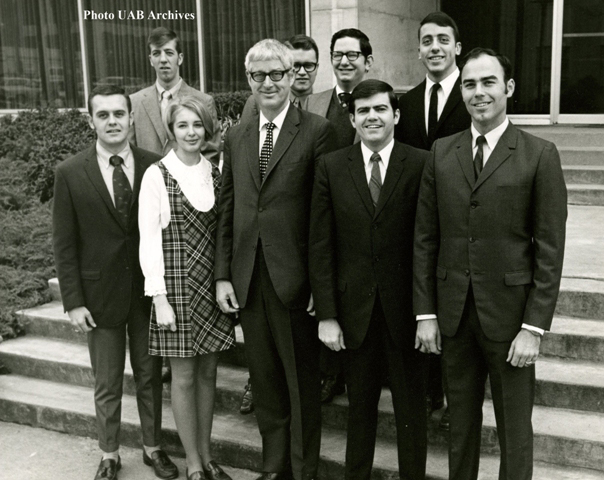 A group of people stand on steps for a photo