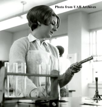 A chemistry student studies a device in the lab