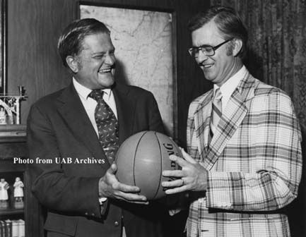 A man hands a basketball to another man