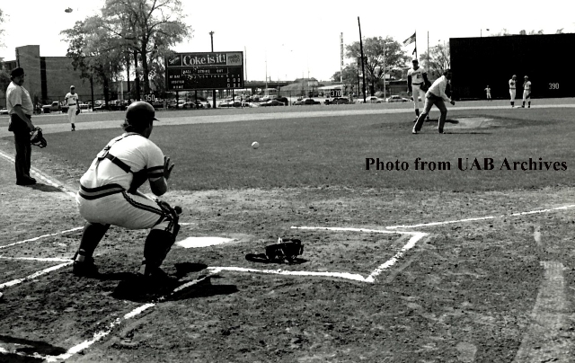 Brooks Robinson throws a baseball towards the catcher