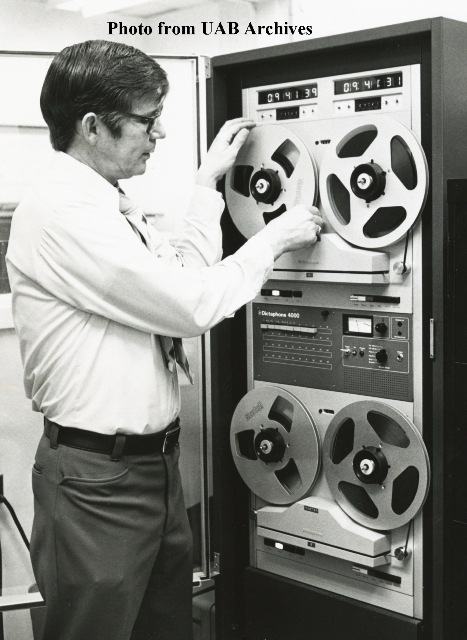 A policeman adjusts a tape machine