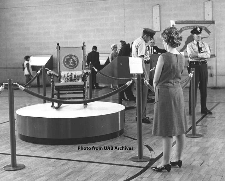 A woman studies a rocking chair owned by President John F. Kennedy