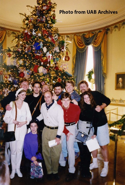 A group of art students pose in front of a Christmas tree in the White House