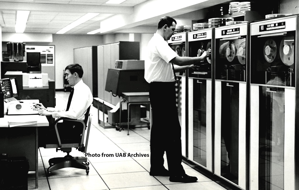 Two male employees working in the Hospital Computer Center