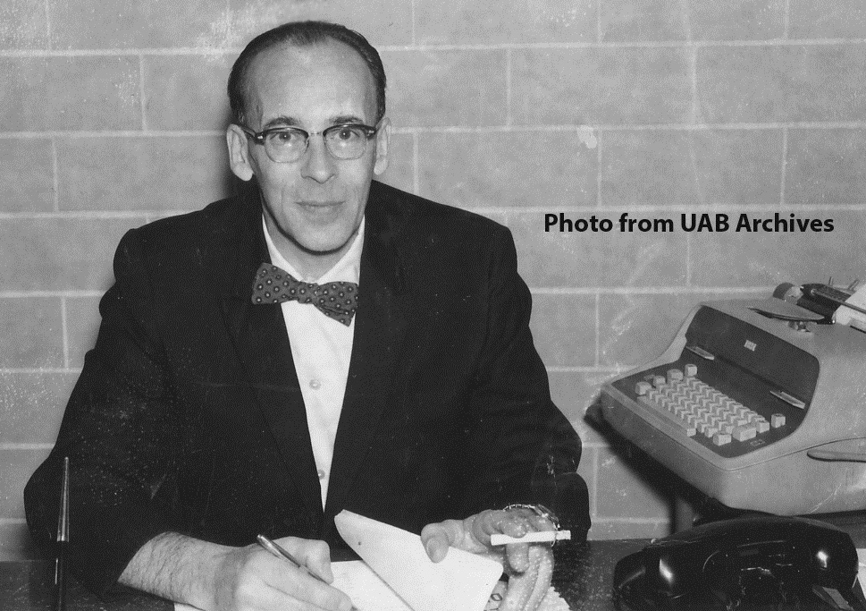 Frederick W. Kraus sits at his desk