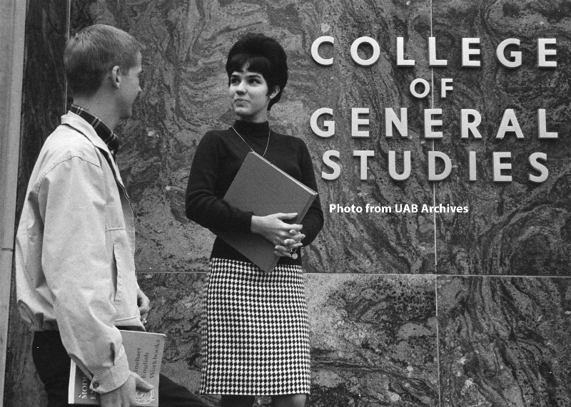 Two students talk outside the College of General Studies building